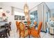 Dining area with a glass-top table and orange chairs at 2918 Sunset Retreat Ct, Kissimmee, FL 34747