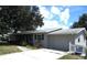 Updated ranch home with grey siding, mature trees, and a fenced yard at 896 N 9Th St, Eagle Lake, FL 33839