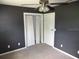 Bedroom with dark walls, ceiling fan, and spacious closet at 896 N 9Th St, Eagle Lake, FL 33839