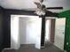 Bedroom with dark and green walls, ceiling fan, and spacious closet at 896 N 9Th St, Eagle Lake, FL 33839