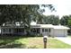 Ranch style home with grey siding and a two-car garage at 896 N 9Th St, Eagle Lake, FL 33839