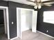 Bedroom with dark walls, ceiling fan, and spacious closet at 896 N 9Th St, Eagle Lake, FL 33839