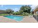 Community pool with lounge chairs and brick pavers at 621 Knightsbridge Cir, Davenport, FL 33896