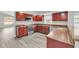 Modern kitchen with dark wood cabinets, granite counters, and stainless steel appliances at 621 Knightsbridge Cir, Davenport, FL 33896