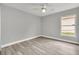 Bright bedroom featuring neutral walls and wood-look flooring at 621 Knightsbridge Cir, Davenport, FL 33896