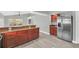 Modern kitchen with dark wood cabinets, granite counters, and stainless steel appliances at 621 Knightsbridge Cir, Davenport, FL 33896