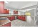 Modern kitchen with dark wood cabinets, granite counters, and stainless steel appliances at 621 Knightsbridge Cir, Davenport, FL 33896