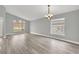 Spacious living room with gray walls, wood-look floors, and large window at 621 Knightsbridge Cir, Davenport, FL 33896