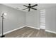 Spacious bedroom with ceiling fan, built-in shelving and wood-look flooring at 621 Knightsbridge Cir, Davenport, FL 33896