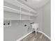 Laundry room with white utility sink and ample shelving at 621 Knightsbridge Cir, Davenport, FL 33896