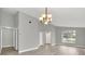 Bright living room with gray walls, wood-look floors, and large window at 621 Knightsbridge Cir, Davenport, FL 33896