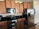 Kitchen features stainless steel appliances and dark countertops at 1816 Stargazer Trl, Kissimmee, FL 34758