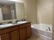 Bathroom features double vanity, soaking tub, and tile floor at 1816 Stargazer Trl, Kissimmee, FL 34758