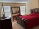 Bedroom with a red bedspread and built-in desk at 1816 Stargazer Trl, Kissimmee, FL 34758