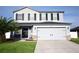 Two-story home with gray siding, black shutters, and a two-car garage at 1816 Stargazer Trl, Kissimmee, FL 34758
