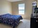 Bedroom with a blue and white bedspread at 1816 Stargazer Trl, Kissimmee, FL 34758