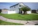 Two-story house with a large front yard, white fence, and palm tree at 1816 Stargazer Trl, Kissimmee, FL 34758