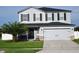 Two-story home with gray siding, black shutters, and a two-car garage at 1816 Stargazer Trl, Kissimmee, FL 34758