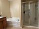 Bathroom with soaking tub and separate shower stall at 1816 Stargazer Trl, Kissimmee, FL 34758