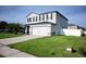 Two-story home with gray siding, black shutters, and a two-car garage at 1816 Stargazer Trl, Kissimmee, FL 34758