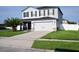 Two-story home with gray siding, black shutters, and a two-car garage at 1816 Stargazer Trl, Kissimmee, FL 34758