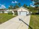 House exterior featuring a paved driveway and American flag at 2909 Annalee Rd, Saint Cloud, FL 34771