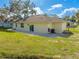Back of the house with a patio, grassy area and trees at 2909 Annalee Rd, St Cloud, FL 34771