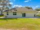 Rear view of house showcasing a patio and grassy area at 2909 Annalee Rd, St Cloud, FL 34771
