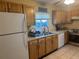 Classic kitchen with wood cabinets, and a window overlooking backyard at 3000 Cashmere Dr, Orlando, FL 32827