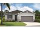 One-story home with gray siding, brown roof, and attached garage at 648 Hennepin Loop, Lake Wales, FL 33898