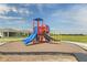 Community playground with slides, climbing structures, and safety surfacing at 196 Flag Lilly Ln, Umatilla, FL 32784