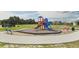 Community playground with slides, climbing structures, and safety surfacing at 196 Flag Lilly Ln, Umatilla, FL 32784
