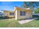 Yellow single story home with a front yard and walkway at 402 Tuscarora St, Lakeland, FL 33805