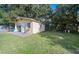 Detached garage with concrete slab and grassy yard at 402 Tuscarora St, Lakeland, FL 33805