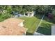 Aerial view showcasing a home's backyard, detached garage, and shed at 402 Tuscarora St, Lakeland, FL 33805