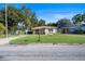 Cute yellow house with a well-maintained lawn at 402 Tuscarora St, Lakeland, FL 33805