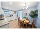 Eat-in kitchen featuring a round table and chairs, white cabinets, and granite countertops at 402 Tuscarora St, Lakeland, FL 33805