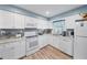 White kitchen with granite countertops and stainless steel appliances at 402 Tuscarora St, Lakeland, FL 33805
