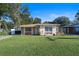 Nice yellow house with stone accents and a lawn at 402 Tuscarora St, Lakeland, FL 33805