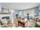 Living room with light blue walls, hardwood floors, and a fireplace at 402 Tuscarora St, Lakeland, FL 33805