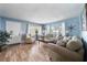 Living room showcasing hardwood floors, soft seating, and a view of the front door at 402 Tuscarora St, Lakeland, FL 33805