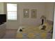 Bedroom with yellow and gray bedding and a dresser at 608 Copeland Dr, Haines City, FL 33844