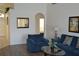 Spacious living room with ample seating and a view into the entryway and another room at 608 Copeland Dr, Haines City, FL 33844