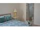 Bedroom with teal bedding and en suite bathroom at 608 Copeland Dr, Haines City, FL 33844
