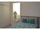 Bedroom with teal bedding and a white dresser at 608 Copeland Dr, Haines City, FL 33844