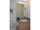 Bathroom with single vanity and light wood cabinets at 608 Copeland Dr, Haines City, FL 33844