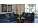 Living Room with blue couches and sliding glass doors to patio at 608 Copeland Dr, Haines City, FL 33844