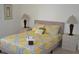 Main bedroom with a king-size bed, two nightstands, and yellow and gray bedding at 608 Copeland Dr, Haines City, FL 33844