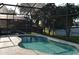 Kidney shaped screened-in pool at 608 Copeland Dr, Haines City, FL 33844