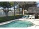 Screened-in pool and patio area with lounge chairs at 608 Copeland Dr, Haines City, FL 33844